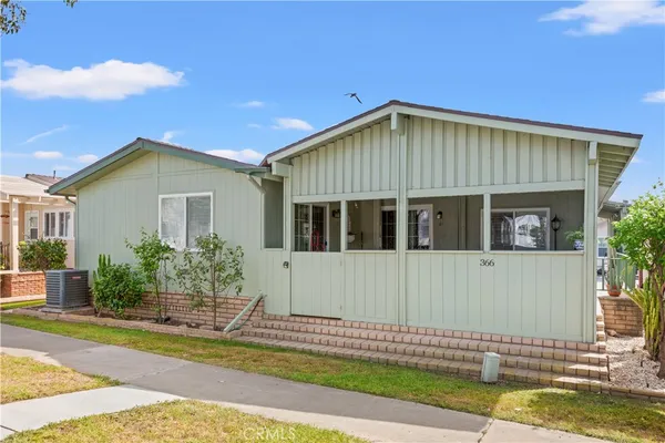 a view of a house with swimming pool and sitting area