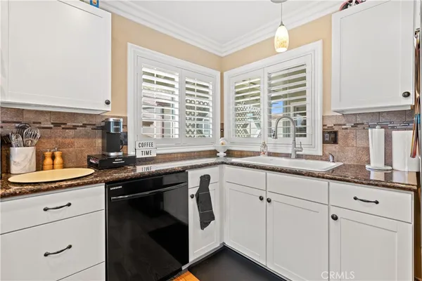 swimming pool view with couple of chairs