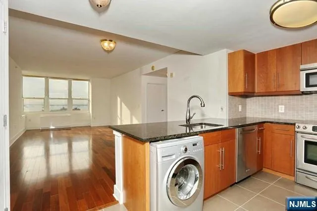 a utility room with sink dryer and washer