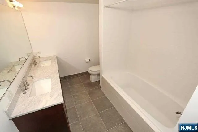 a bathroom with a bathtub and a toilet