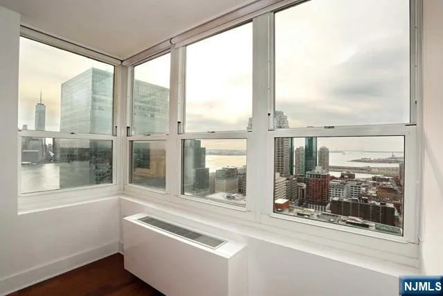 a living room with a large window and front door