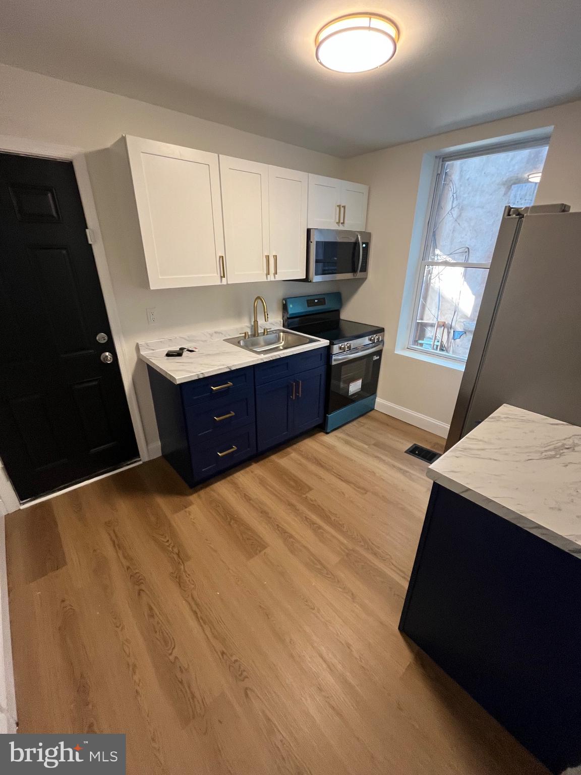 a kitchen with stainless steel appliances kitchen island granite countertop a sink dishwasher stove and cabinets