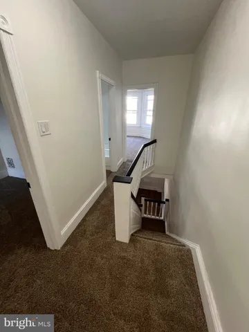 a view of a livingroom with furniture and staircase