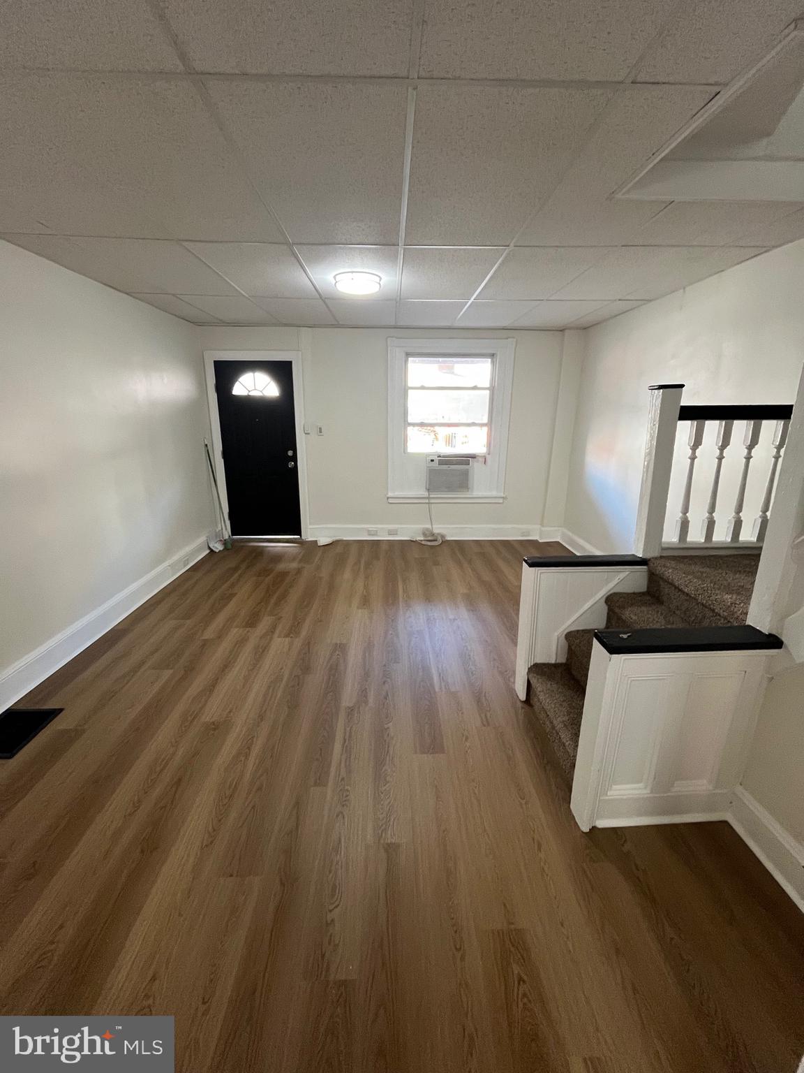 904 South Cecil Street Philadelphia, PA 19143 - Photo 15 of 18 a view of an empty room with wooden floor and a window