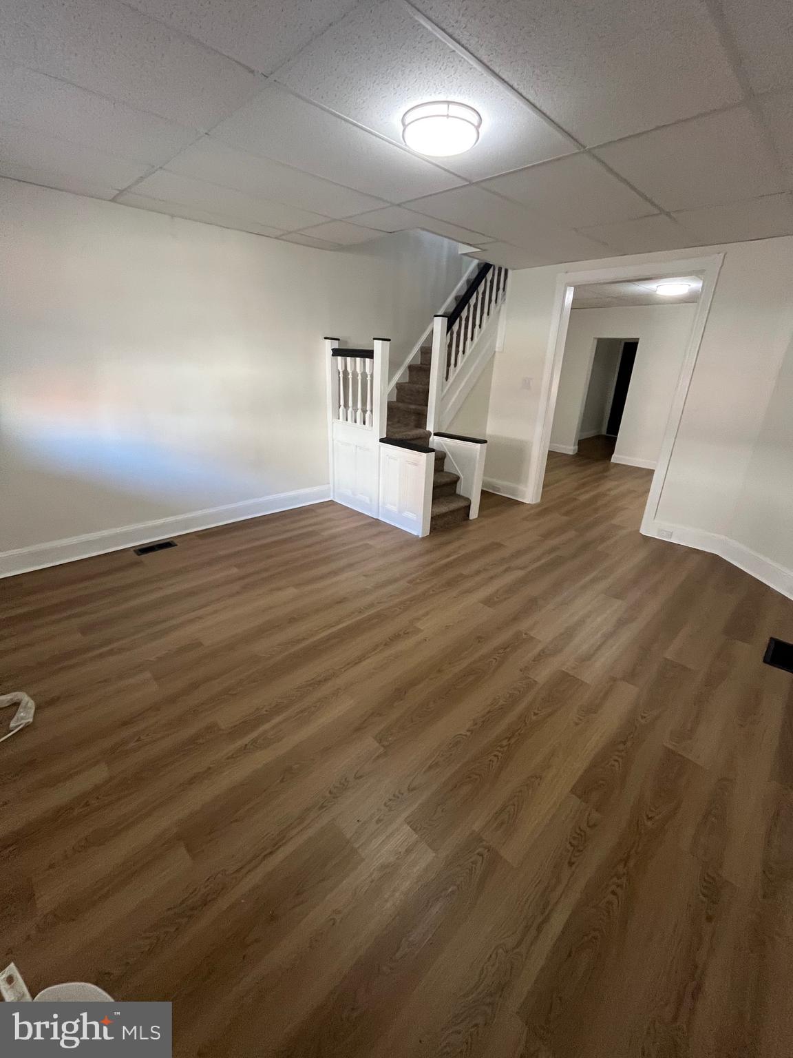 904 South Cecil Street Philadelphia, PA 19143 - Photo 2 of 18 an empty room with wooden floor and windows