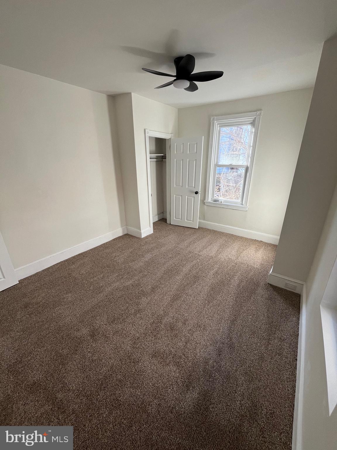 904 South Cecil Street Philadelphia, PA 19143 - Photo 10 of 18 a view of empty room with wooden floor and window