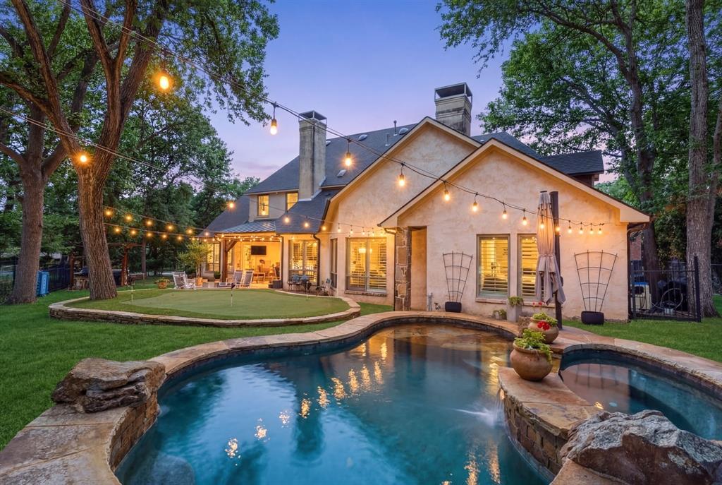 2404 Racheal Drive Heath, TX 75032 - Photo 1 of 40 Exquisite, two-story custom home with designer finishes throughout, and $75K in backyard upgrades, heated pool-spa, putting greens, built-in firepit, extensive string lights and outdoor kitchen.