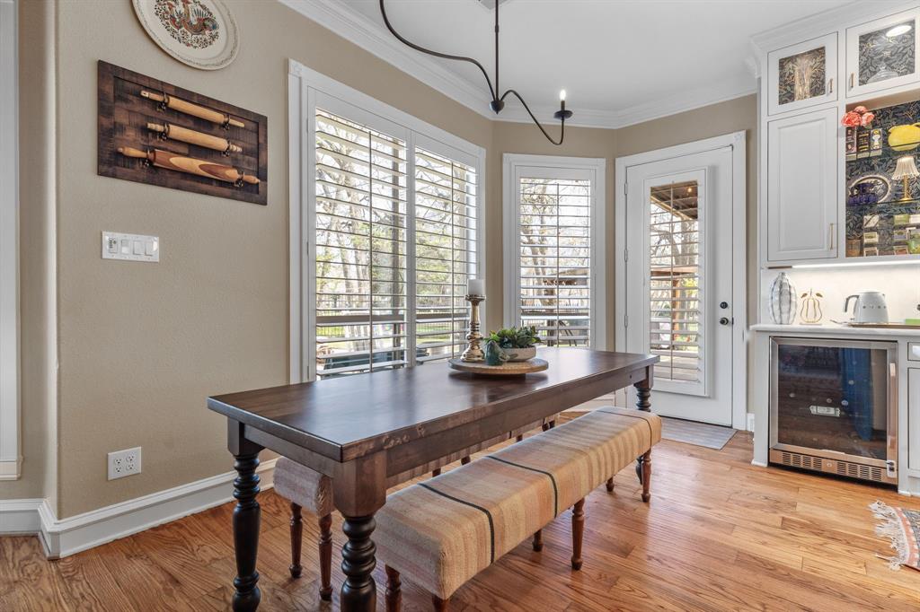 2404 Racheal Drive Heath, TX 75032 - Photo 15 of 40 The breakfast room just off the kitchen offers generous space for a table, anchored by a tasteful Pottery Barn wrought iron chandelier. The space feels bright, airy, and inviting by the light from two large windows with plantation shutters and a glass exterior door leading to the covered back porch.