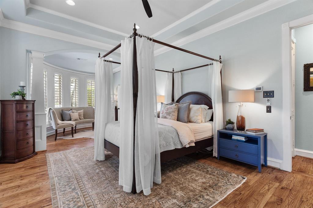 2404 Racheal Drive Heath, TX 75032 - Photo 18 of 40 A tray ceiling with double crown molding and a new contemporary ceiling fan crowns the space, while two tapered columns with an arched entry reveal a sunlit sitting area