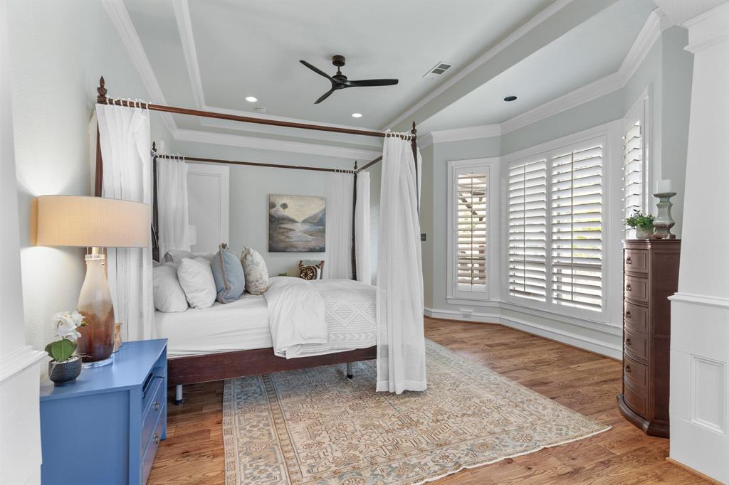 2404 Racheal Drive Heath, TX 75032 - Photo 19 of 40 he private primary suite is a sanctuary of elegance, showcasing brand new hand-scraped oak hardwood floors, a bay window with custom white plantation shutters framing serene putting green views, and a glass exterior door with direct access to the back porch, pool and spa.