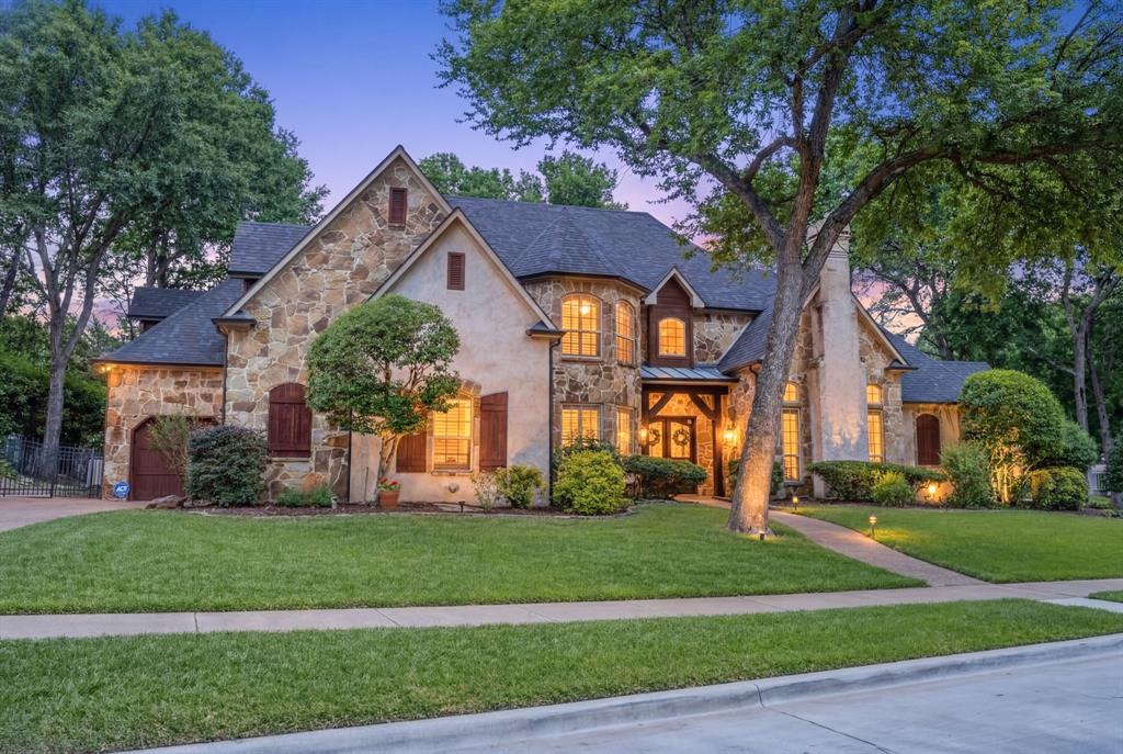 2404 Racheal Drive Heath, TX 75032 - Photo 2 of 40 The home is beautifully landscaped with lush landscape (including a row of limelight hydrangeas for fresh cut flowers all season), fresh mulch, stone hardscaping, and mature trees. An extended driveway leads to a side-entry two-car garage and additional front-entry single-car or golf cart garage, all enhanced with upgraded cedar wooden garage doors.
