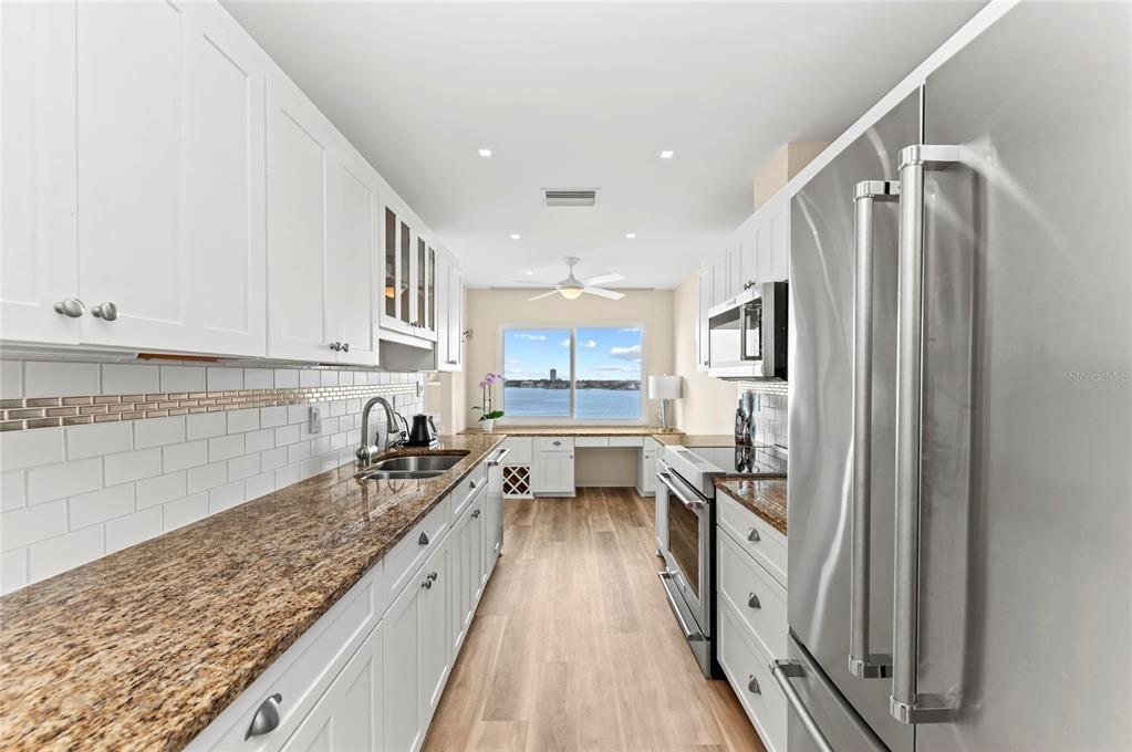 350 Golden Gate Point, Unit 61 Sarasota, FL 34236 - Photo 23 of 48 a kitchen with granite countertop lots of counter top space and stainless steel appliances