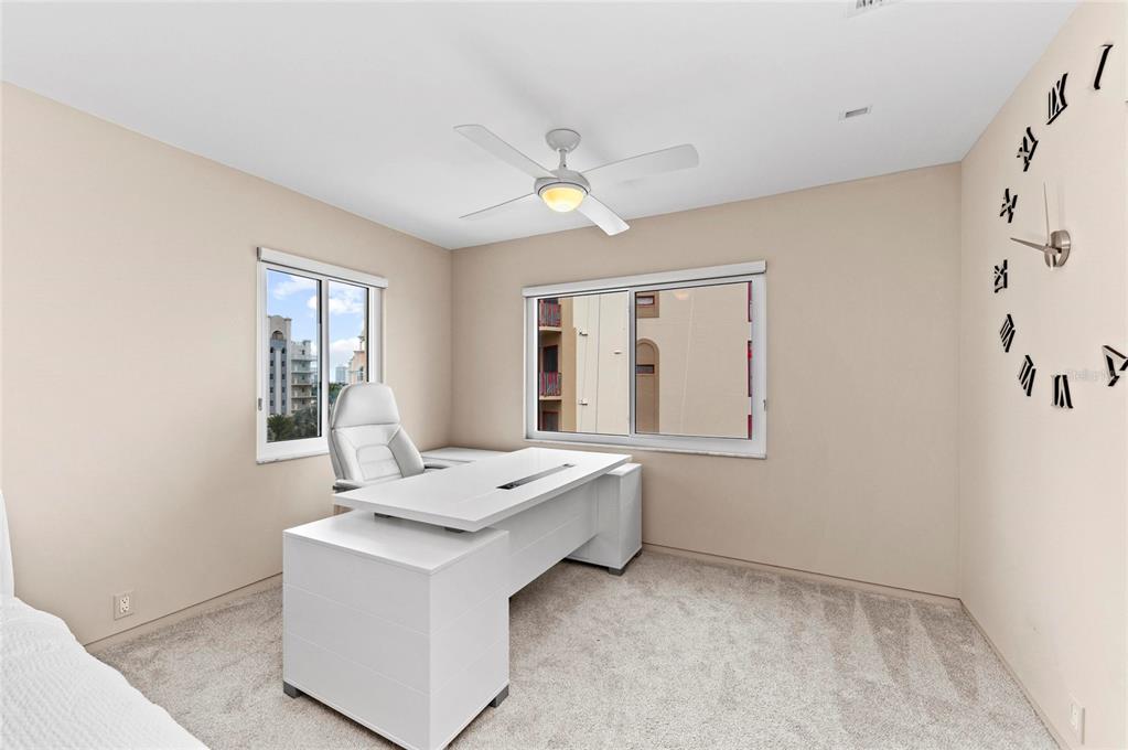 350 Golden Gate Point, Unit 61 Sarasota, FL 34236 - Photo 26 of 48 a room with a bed furniture and a window