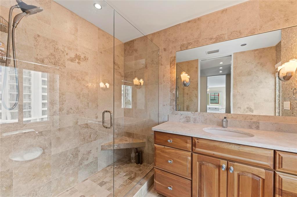 350 Golden Gate Point, Unit 61 Sarasota, FL 34236 - Photo 32 of 48 a bathroom with a granite countertop sink a toilet and shower