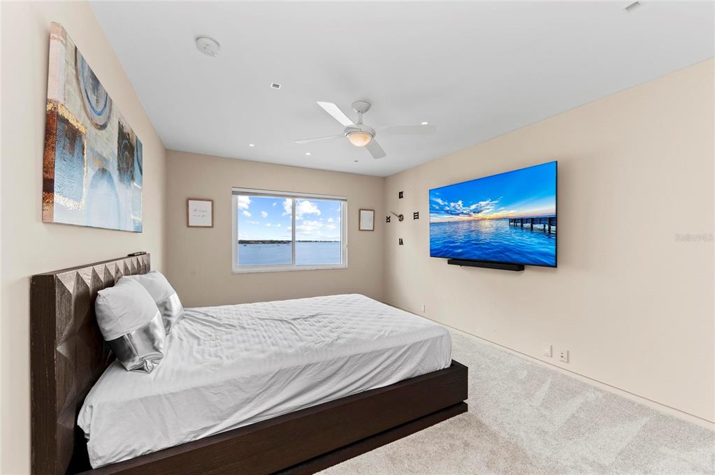350 Golden Gate Point, Unit 61 Sarasota, FL 34236 - Photo 34 of 48 a bedroom with a bed and a painting on the wall