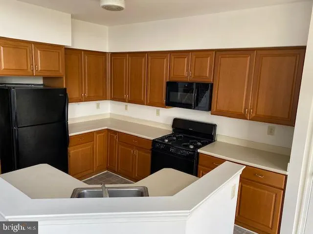 a kitchen with a sink and a refrigerator