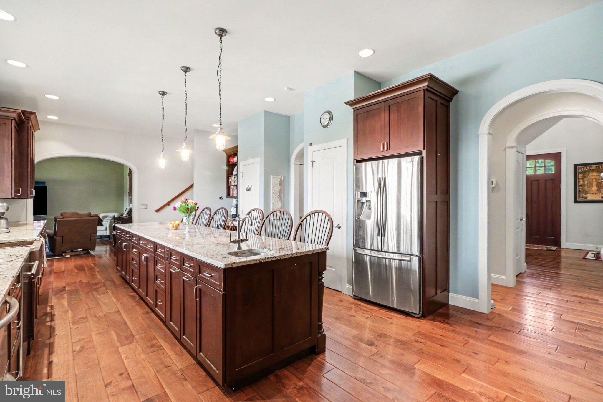 1080 Swatara Road Hershey, PA 17033 - Photo 4 of 59 a kitchen with stainless steel appliances granite countertop a kitchen island a refrigerator a sink dishwasher a oven and a dining table with wooden floor