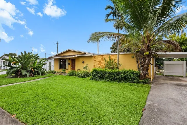 a front view of house with yard and outdoor seating