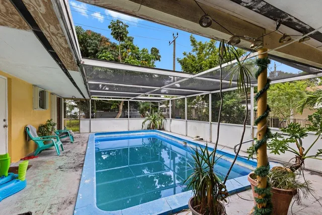 a view of a porch with furniture and a potted plant