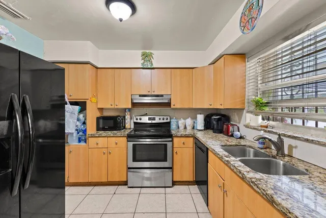 a kitchen with a sink appliances and cabinets