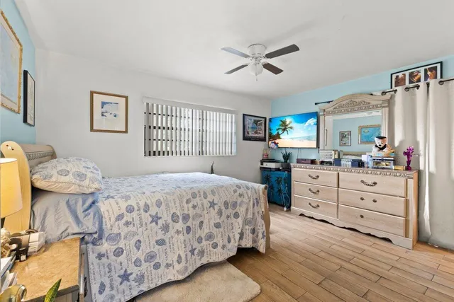 a bedroom with a bed and a dresser in it