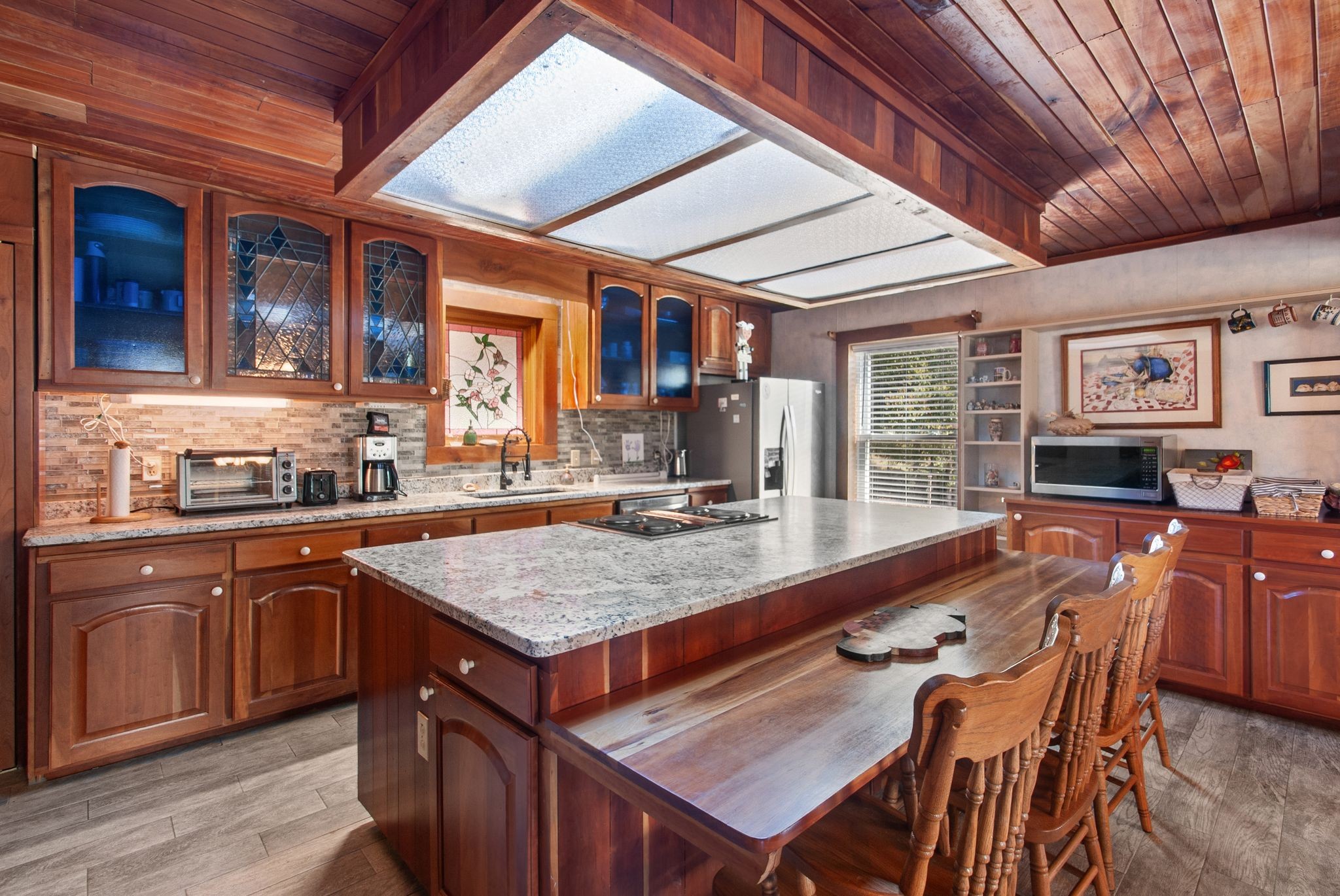 1927 Fowler Hollow Road Lynnville, TN 38472 - Photo 10 of 77 a dining hall with stainless steel appliances granite countertop a stove a sink dishwasher and cabinets with wooden floor