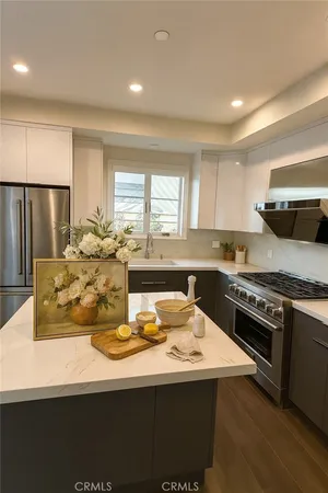 a kitchen with a stove a sink and a refrigerator