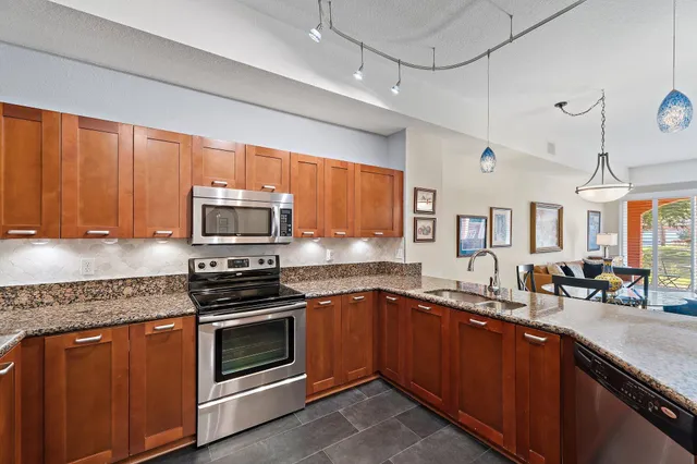 a dining room with wooden floor a chandelier a wooden table and chairs