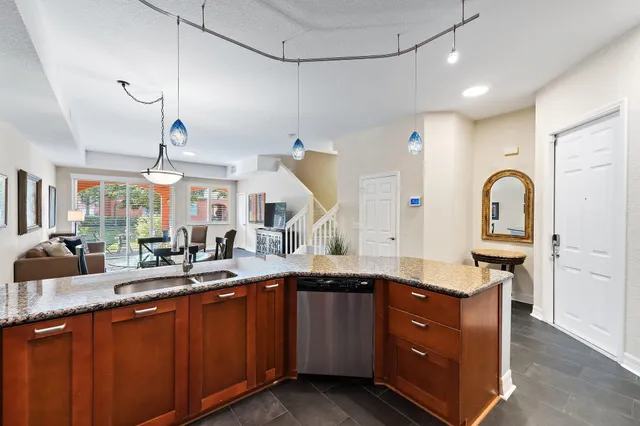 a living room with furniture a window and a wooden floor