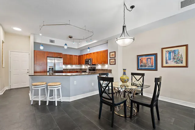 a view of a dining room with furniture a rug and wooden floor