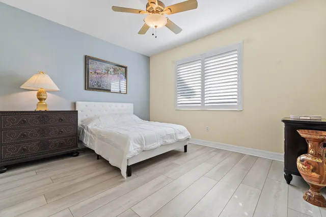 a view of a room with a chandelier fan and windows