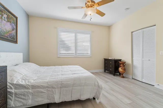 a bathroom with a granite countertop sink a mirror and a shower