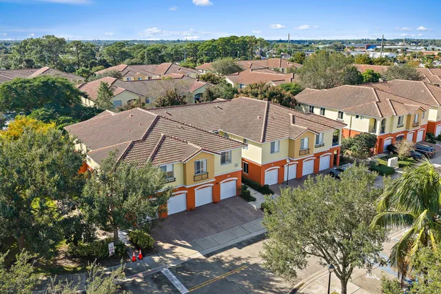 an aerial view of residential houses with outdoor space and street view