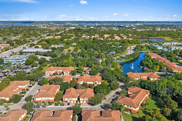 an aerial view of a city with lots of residential buildings ocean and mountain view