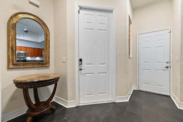 a kitchen with a refrigerator a stove dining table and chairs