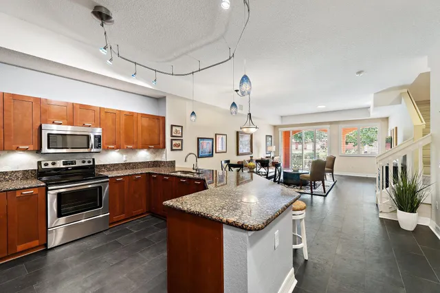 a kitchen with stainless steel appliances a stove sink and microwave