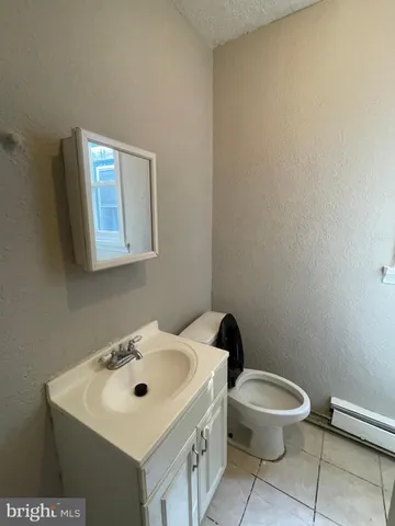 a white toilet sitting next to a bathroom sink
