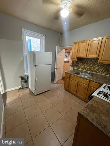 a kitchen with a stove a refrigerator and cabinets