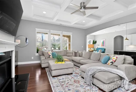 a living room with furniture fireplace and a flat screen tv