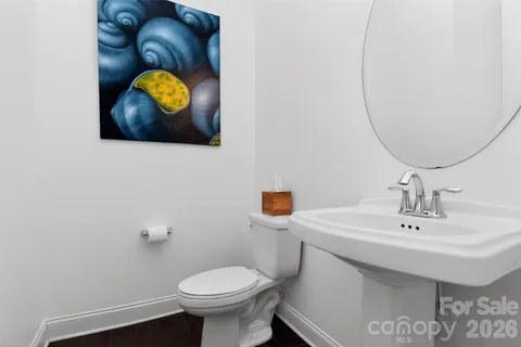 a bathroom with a sink mirror and toilet