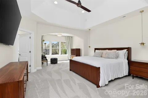 a bedroom with a large bed and a couch