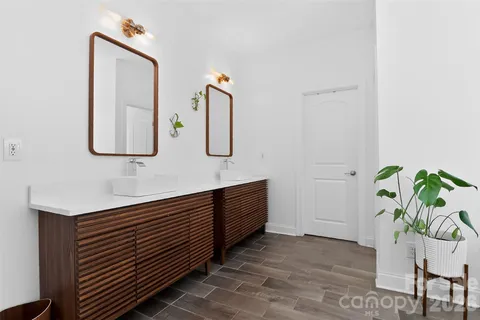 a bathroom with mirror and window