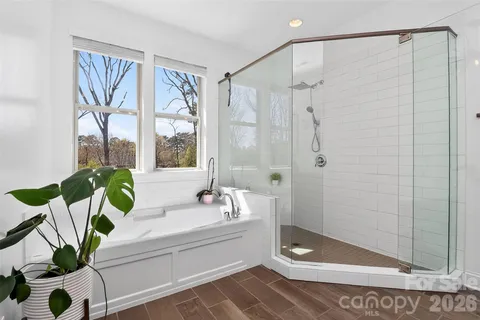 a bathroom with a bathtub shower and a sink