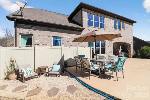 a view of a patio with table and chairs under an umbrella