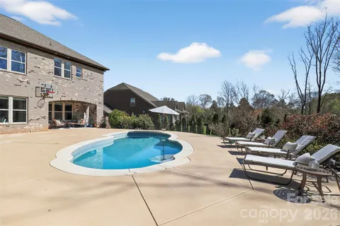 a view of a swimming pool with a lounge chairs