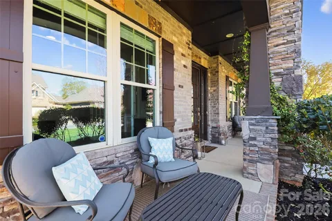 a view of a patio with couches table and chairs and potted plants