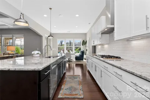 a kitchen with granite countertop lots of counter top space sink and stainless steel appliances
