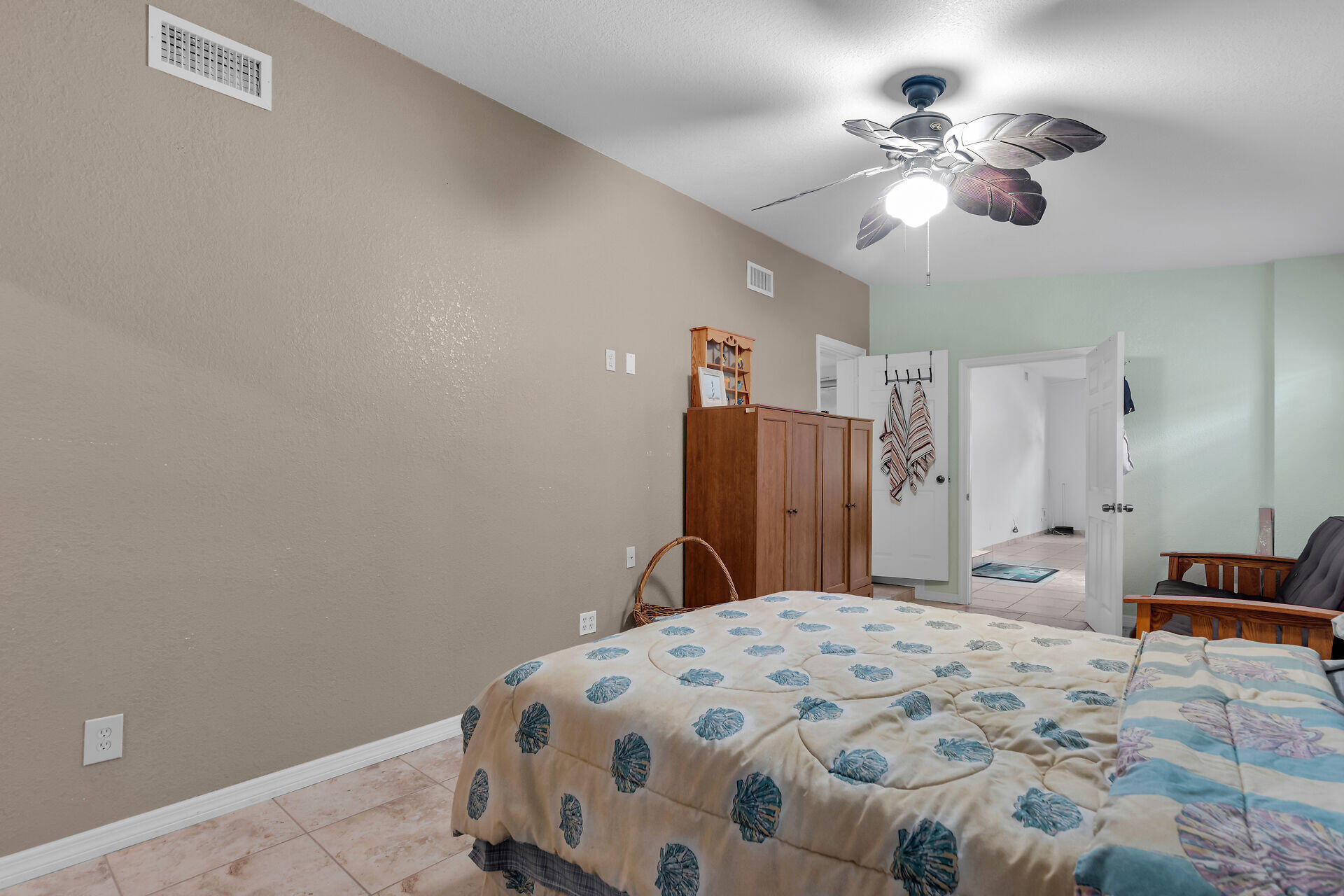 72 1st Court Key Largo, FL 33037 - Photo 14 of 30 a bedroom with a large bed and a chandelier