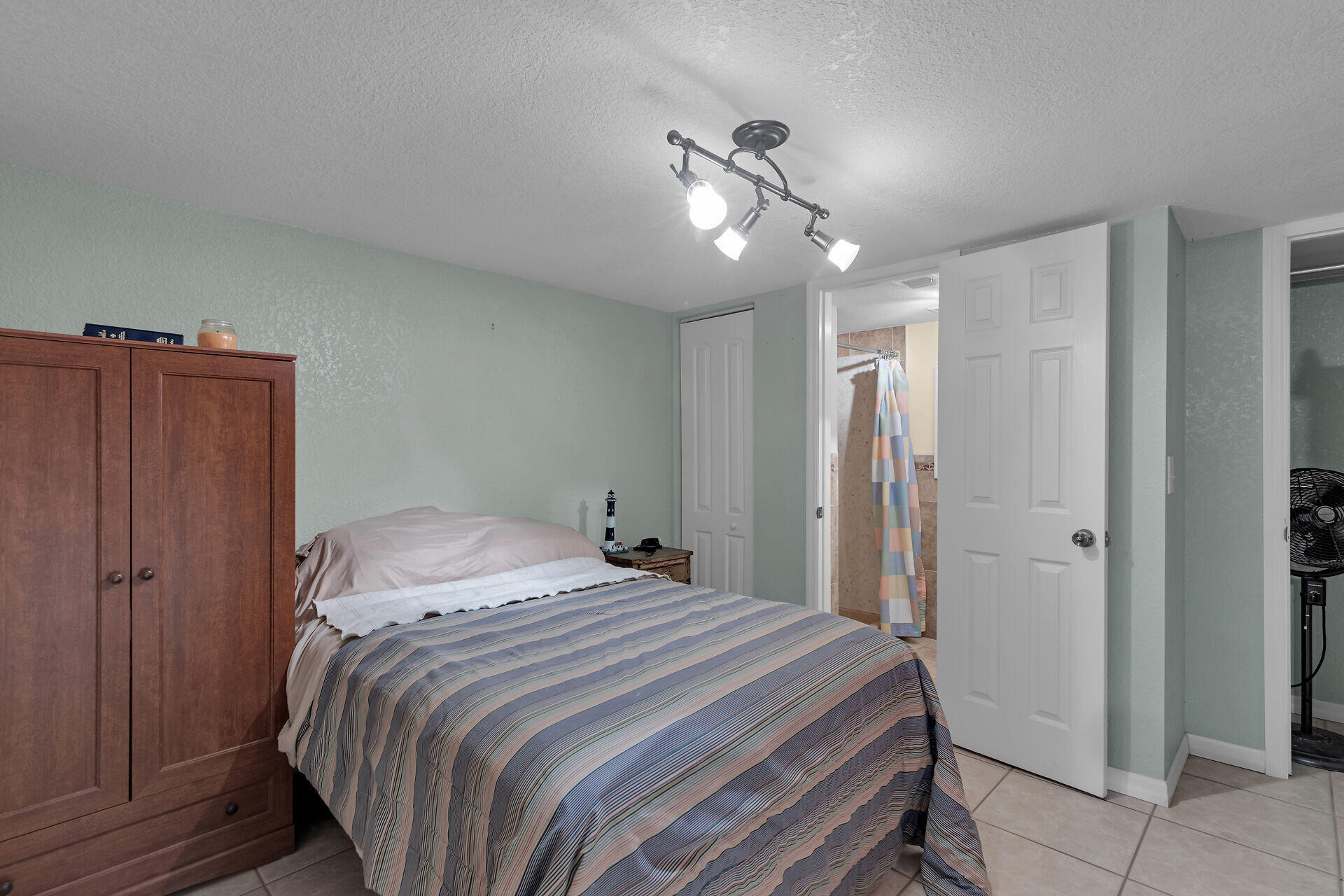 72 1st Court Key Largo, FL 33037 - Photo 18 of 30 a bedroom with a bed and cabinets