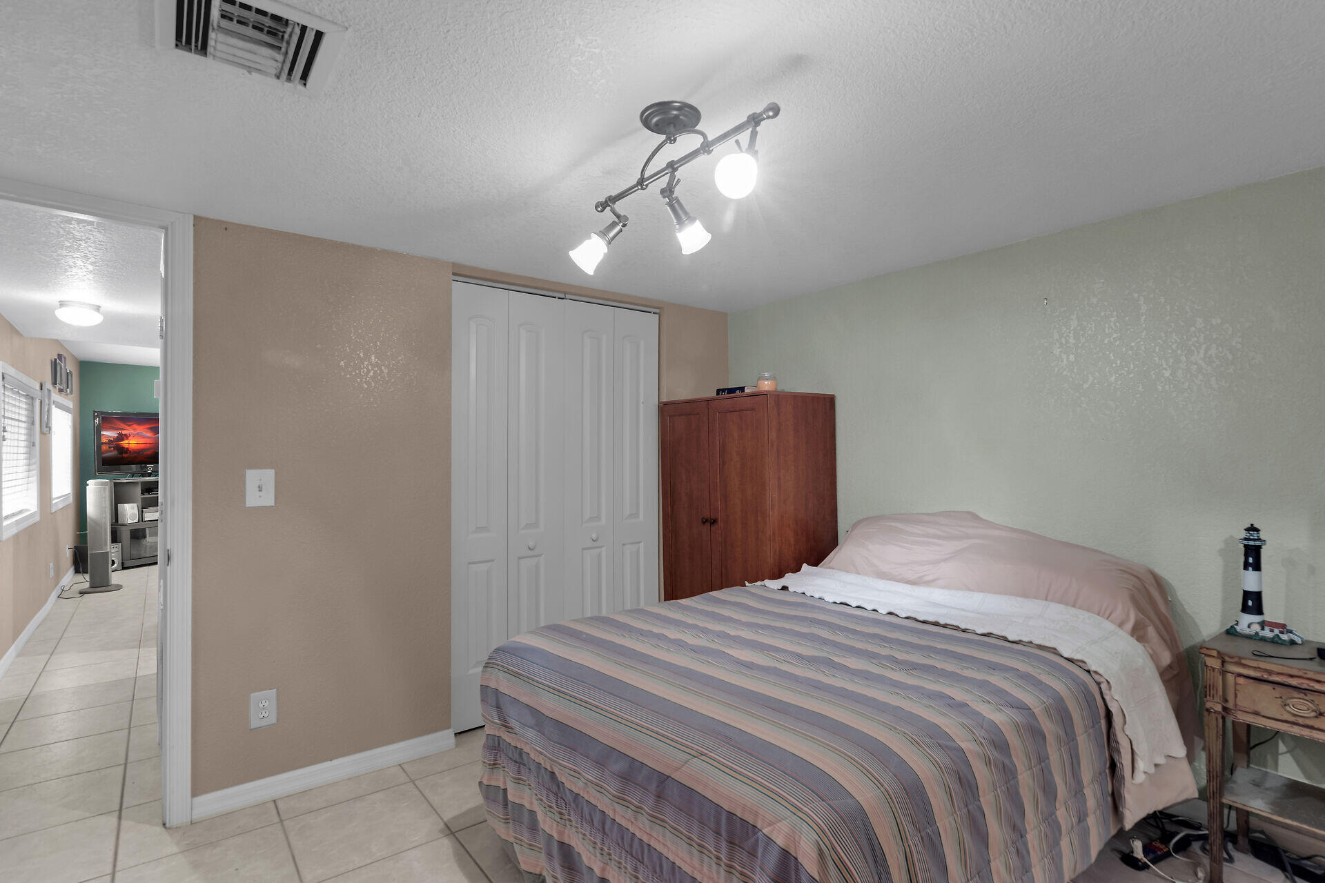 72 1st Court Key Largo, FL 33037 - Photo 19 of 30 a bedroom with a bed and a chandelier